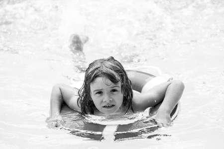 Kids summer. Pool resort. Smilling boy at aquapark. Child swimming in water. Activities in pool. Summertime vacation.の写真素材