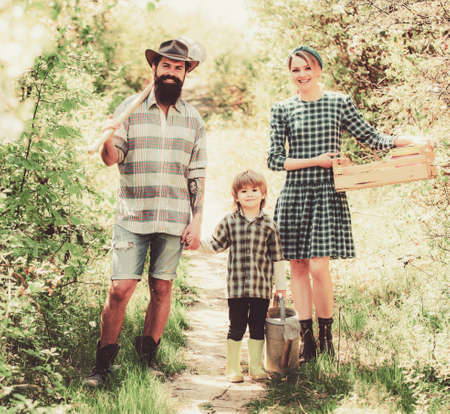 Family working together on farm. Family in the farm on countryside background. Become organic farmers.の写真素材