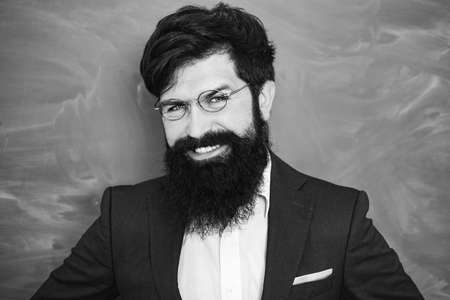 Academic success is much more about hard work than inborn talent. School concept. Young teacher. Exam in college. Portrait of male University Student indoors.の写真素材