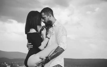 Love and flirt. Muscular man and fit slim young female kissing. Couple goals. Erotica. Sexy couple...