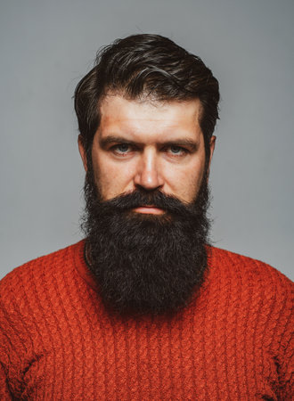Portrait of serious man with beard and mustache. Hipster thinking. Face expression. Handsome male closeup face.の写真素材