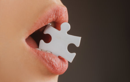 Jigsaw solution. Life problems. Female mouth with puzzle piece.の写真素材