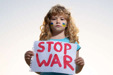 Child protest against war. Portrait kid calls to Stop war, raises banner with inscription stop the...