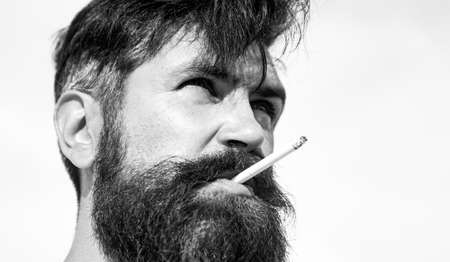 Close up young man smoking a cigarette. Guy smok.の写真素材