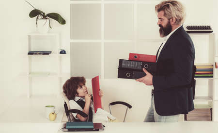Boss and employee. Little boss and mature employee in the office. Colleagues brainstorming in talk....