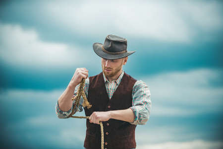 Guy cowboy. Owner of ranch. Farm worker and farming concept. Handsome man in cowboy hat and rustic...