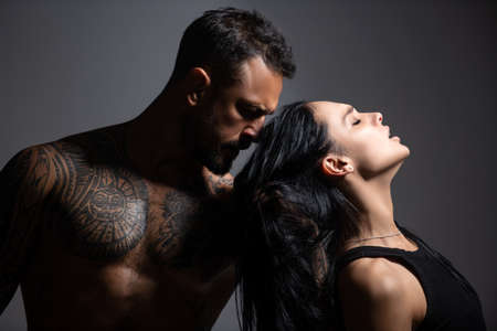 Lovely sexy couple in love. Man embrace sensual woman. Fashion and beauty, romantic guy and girl. Romantic couples embraces. Sexy elegant couple in the tender passion. Beautiful woman near the man.の写真素材