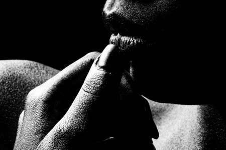 Gold paint on woman face. Golden lips closeup. Gold metal lip. Beautiful makeup. Golden lip gloss on beauty female mouth, closeup.の写真素材