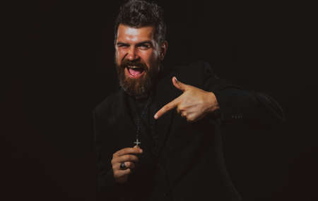 Funny beard monk priest and large wooden cross. Look at this.の写真素材