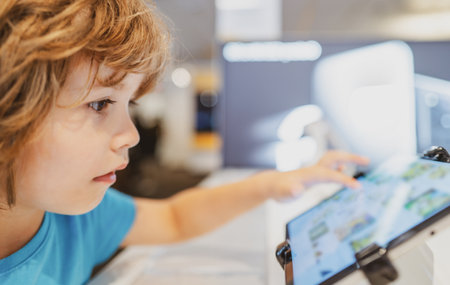 Kid in computer shop. Digital equipment and electronics. Sale of laptops.の写真素材