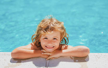 Child relax in summer swimming pool. Kid playing outdoors. Summer vacation and healthy lifestyle...