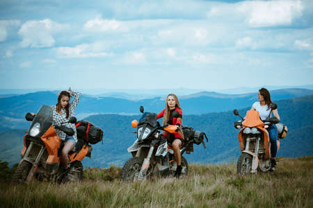 Group of sexy woman on motorcycle. Woman rider, active girsl riding on the motorbike in bikers tour...