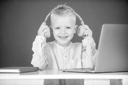 Child boy in headphones study online, child in earphones take Internet web lesson. Knowledge day.の写真素材