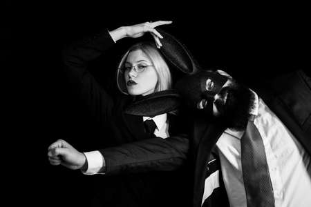 Bearded hipster with woman in suit is ready for carnival. Lovers are fooling around. Rabbit man...