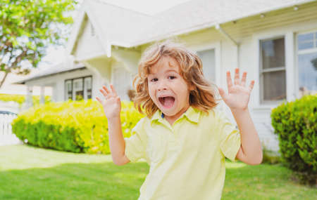 Kids funny face having fun outdoors. Happy child having fun on backyard outdoors.の写真素材