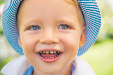 Cute little boy with blue eyes closeup. Portrait of happy kid outdoors. Emotional little boy, surprised little children. Happy kids emotions, smiling face. Blonde kid, emotion face.の写真素材