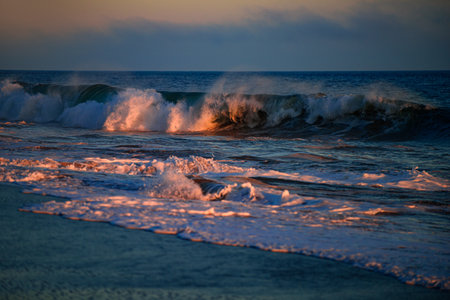 Sea waves background. Sunset with large yellow sun under the sea surface. Waves splashes.の写真素材