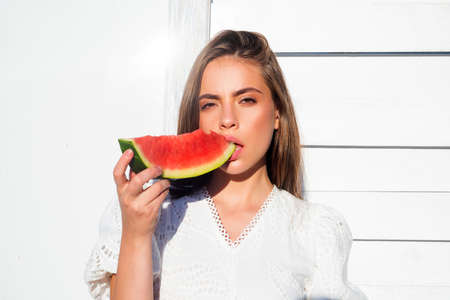 Summer portrait woman is holding a slice of watermelon.の写真素材