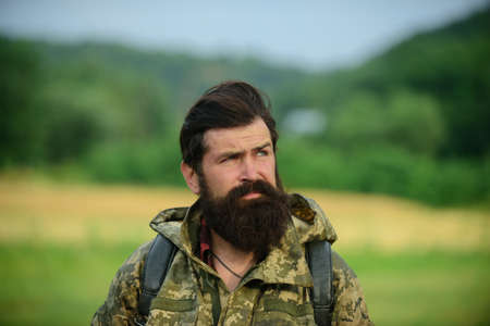 Middle aged farmer, closeup male farmer portrait. Portrait of middle aged bearded man, outdoors in...