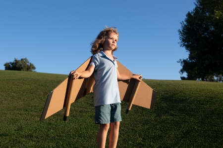 Child boy playing and dreaming about vacation and travel. Kids imagination and freedom concept.