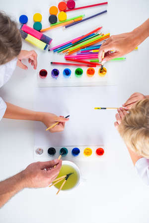 Humans hand is drawing with colorful pencils. Artist painting, drawing art. Top view.の写真素材