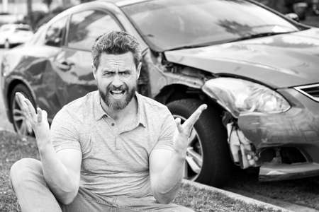 Upset driver man in front of automobile crash car collision accident.の写真素材