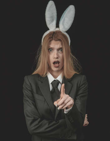 Pretty bunny girl winking and tongue out. Closeup of winking bunny girl face. Sexy woman wearing a black Easter Bunny.の写真素材