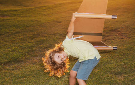 Funny child dreams of becoming a rocket pilot. Imagination and motivation concept. Expression kids face.の写真素材