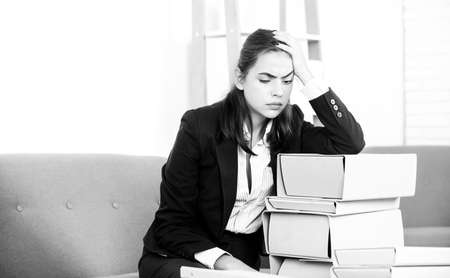 Sad secretary girl, stressed overworked businesswoman too much work, office problem. Tired stressed young woman employee at office.の写真素材