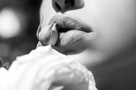 Sexy Lips. Beauty Red Lips Makeup Detail. Lips with spring flowers closeup. Beautiful woman lips...