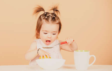 Cute baby child eat food, babies eating. Little baby eating fruit puree.