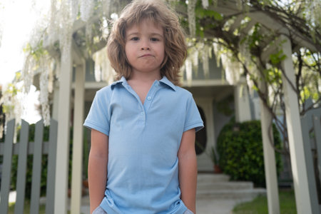 Portrait of fun boy on green background park in nature.