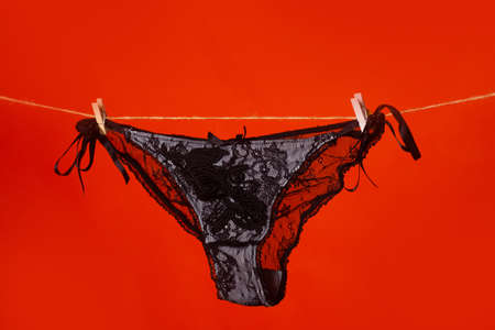 Lace red panties on rope. Cotton underwear. Lace underwear. Womans white erotic lingerie. Womens panties.の写真素材
