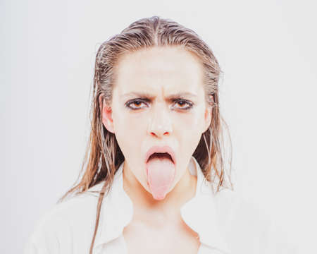 Protesting. Displease Disgust concept. Girl showing tongue in protest.の写真素材