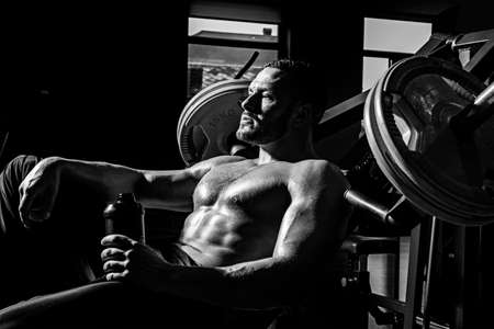 Power, strength and healthy lifestyle, sport. Resting time. Tired sporty man resting after training....