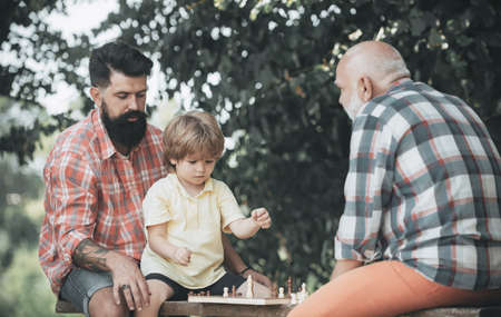 Three different generations ages: grandfather father and son together. Golden age grandfather....