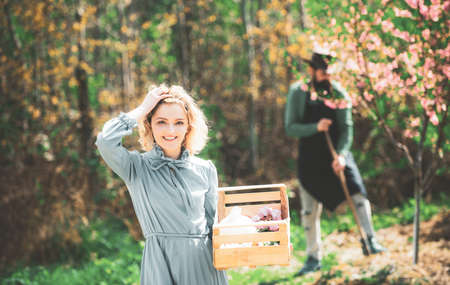 Farming gardening and people concept. Bio food production concept. Farmers couple working in field....