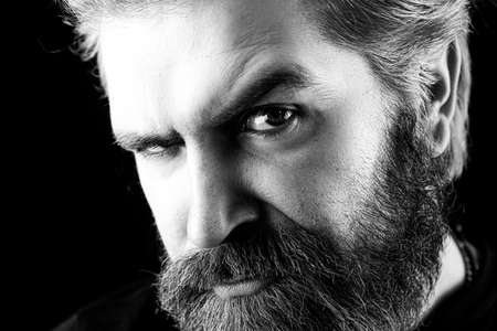 Young handsome sexy man with long beard, mustache and trendy hairdo. Stylish haircut, hairstyle....