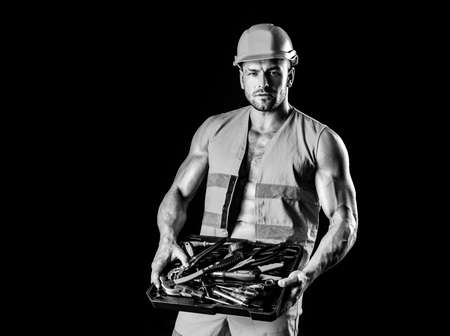 Repairman wearing build helmet hold building tools. Professional worker man.