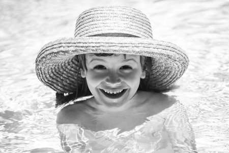 Child relax in summer swimming pool. Summer vacation concept.の写真素材