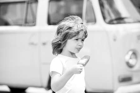 Child eating ice cream. Concept of joy and happiness childhood.