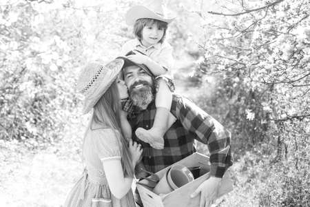 Family gardener on walk in garden or park. Parenthood together leisure concept.の写真素材