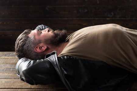 Portrait of handsome man. Bearded guy relaxing, dreaming.