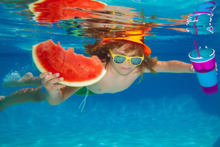 Summer kids portrait in pool water. Underwater boy in the swimming pool. Cute kid boy swimming in pool under water. Summer travelling.の写真素材