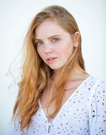 Natural female beauty. Young woman with clean fresh skin on white wall. Sensual portrait of elegant young woman outdoors. Beautiful fashionable girl.の写真素材