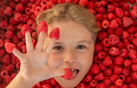 Raspberry isolated. Raspberries child face close up. Top view photo of child face with raspberry. Raspberries set.の写真素材