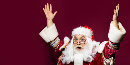 Excited old santa enjoying new year or Christmas, Portrait of mature old santa on red isolated...