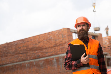 Male construction worker in work clothes and a construction helmet.の写真素材