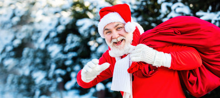 Santa with big bag. Happy new year. Santa magical fog walking along the field. Santa Claus with a...