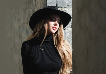 Vogue woman in fashion hat. Fashion outdoor photo of gorgeous sensual woman in elegant dress clothes. Beauty and fashion girl.の写真素材